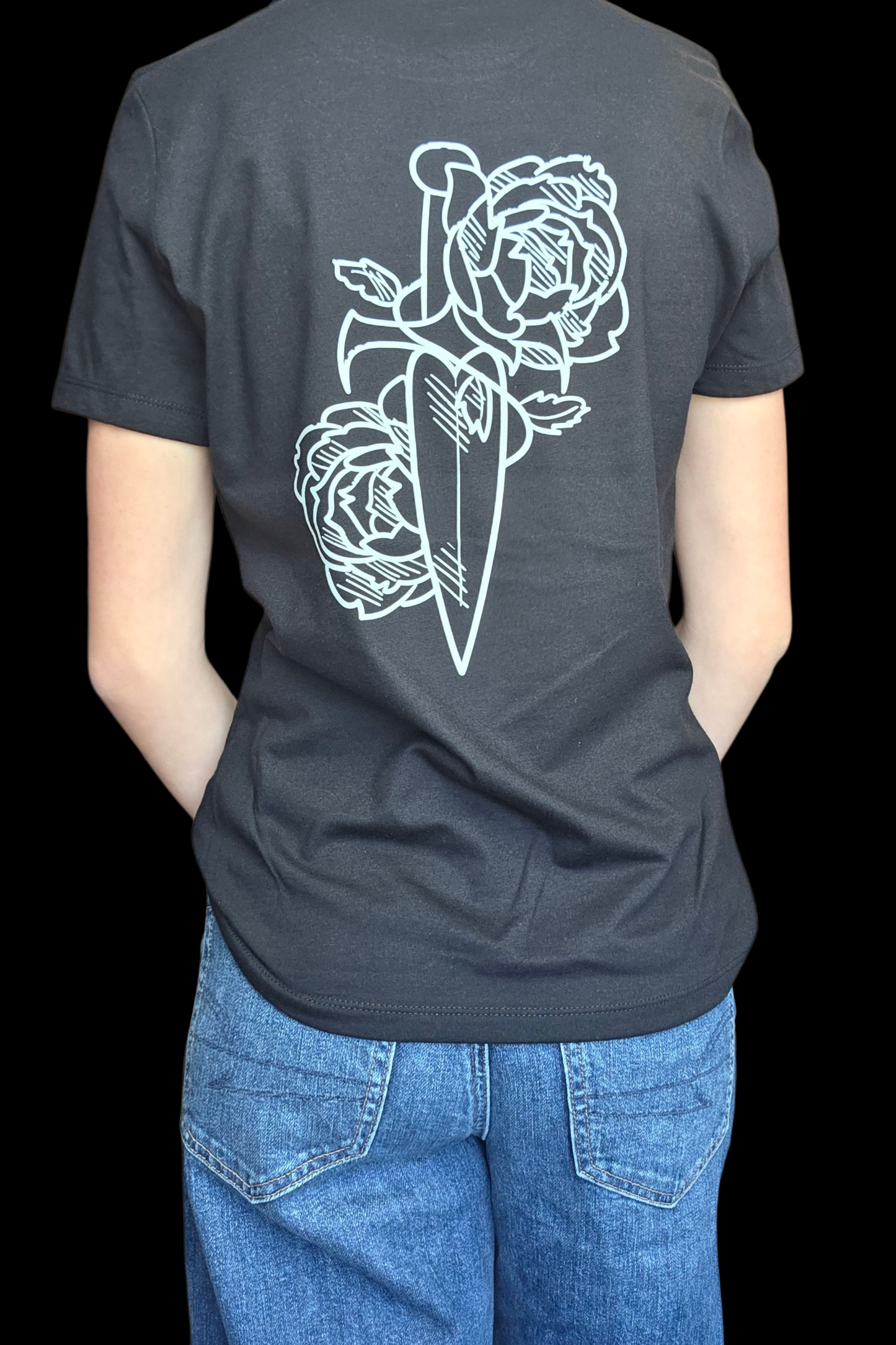 Person wearing a black t-shirt with a white dagger and rose design on the back.