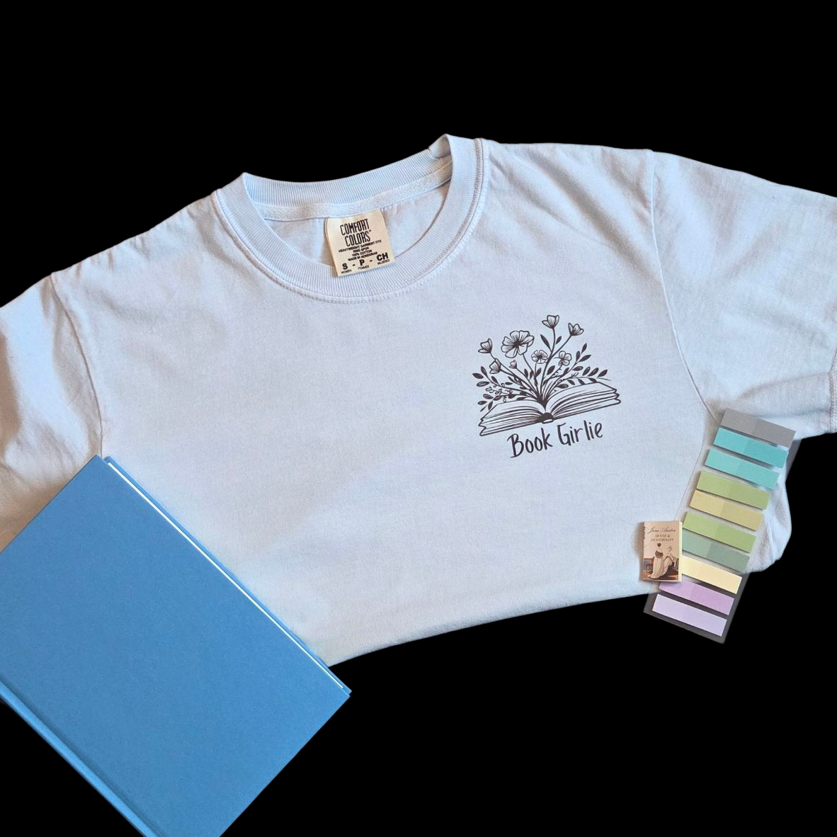 Light blue crop top with a design and text, placed on a black background