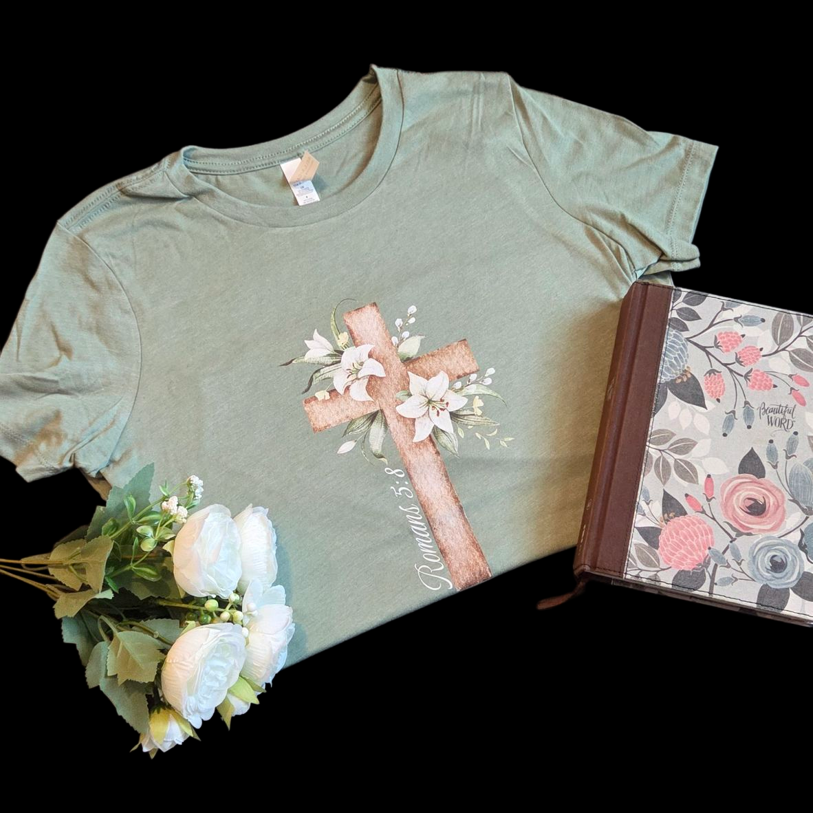 Green t-shirt with floral design on a black background