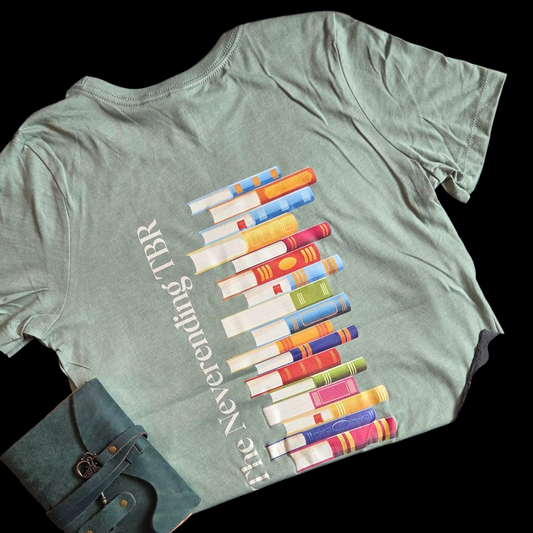 Green t-shirt with colorful book graphic and text on a black background