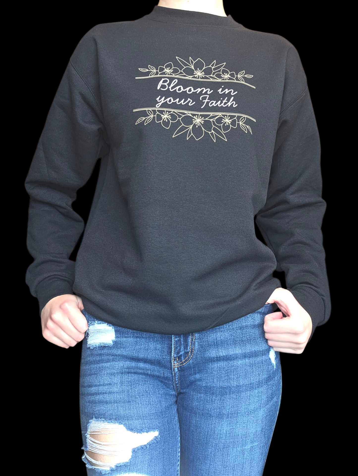 Black crewneck with 'Bloom in your Faith' text and floral design on a black background.